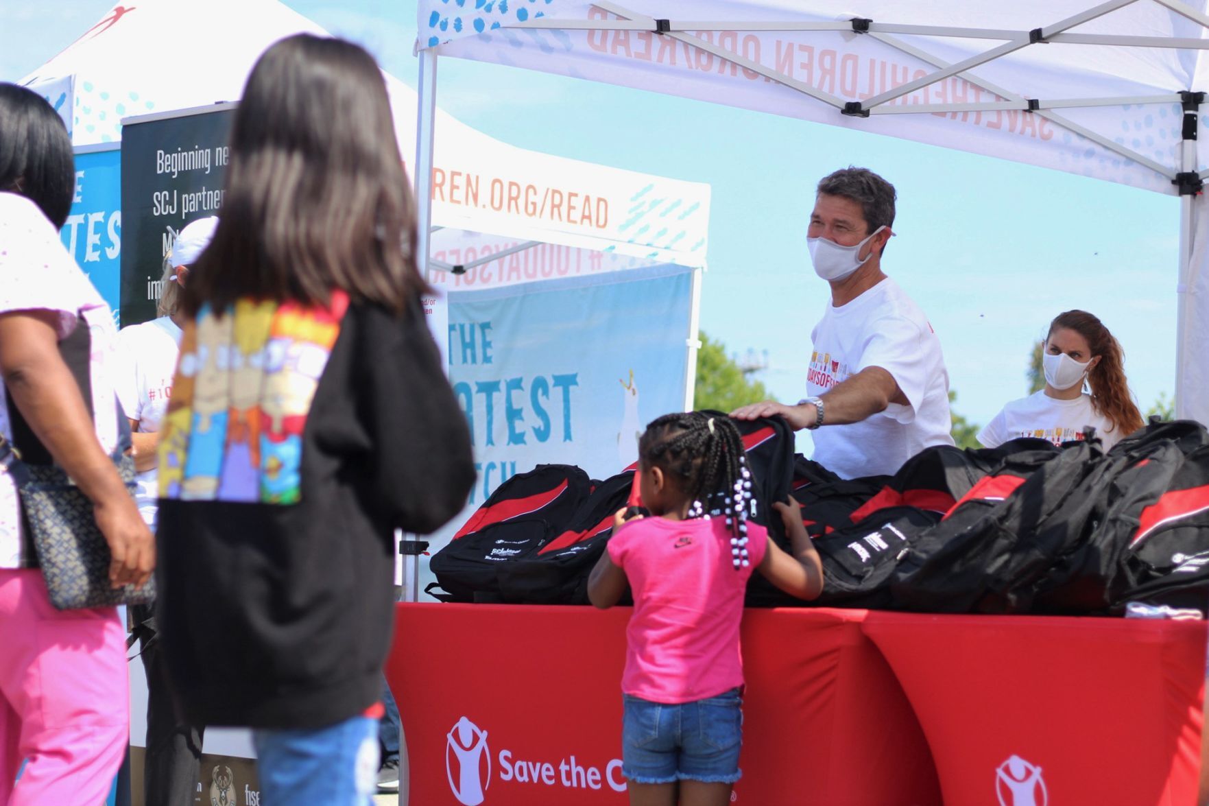 Handing out backpacks
